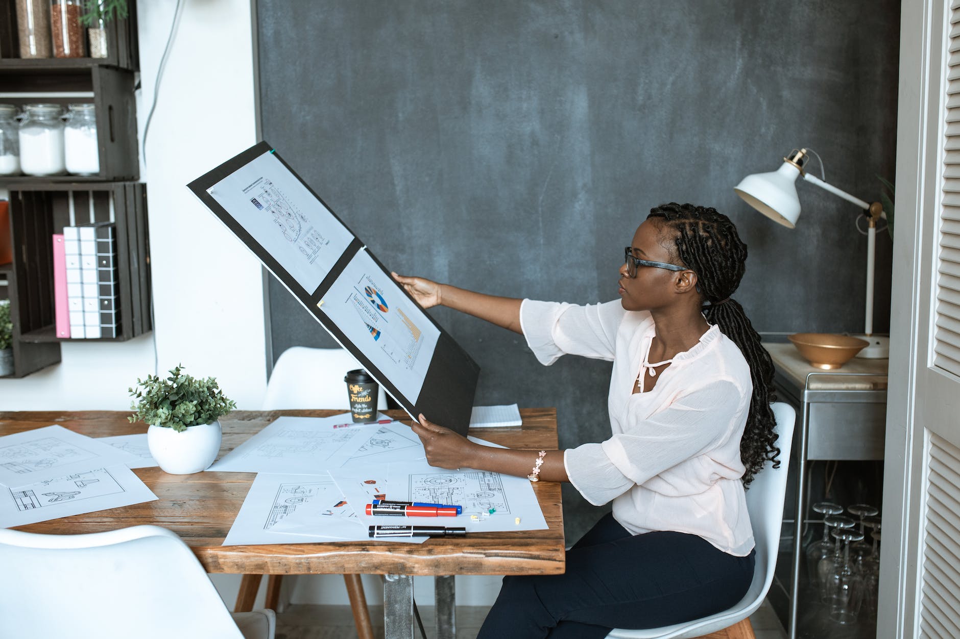 photo of woman looking at her work